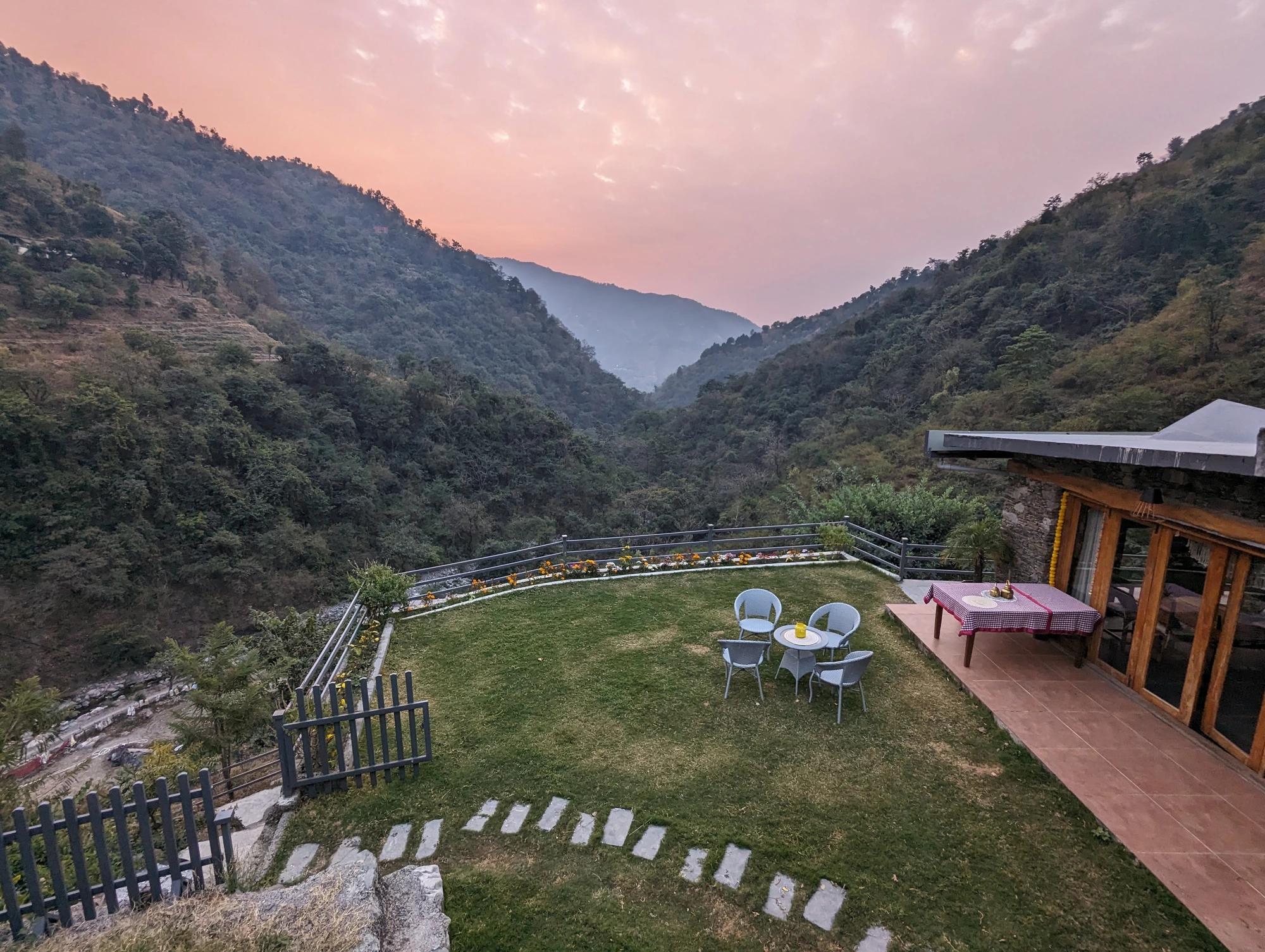The retreat lawn at dusk, with the valley and mountains beyond