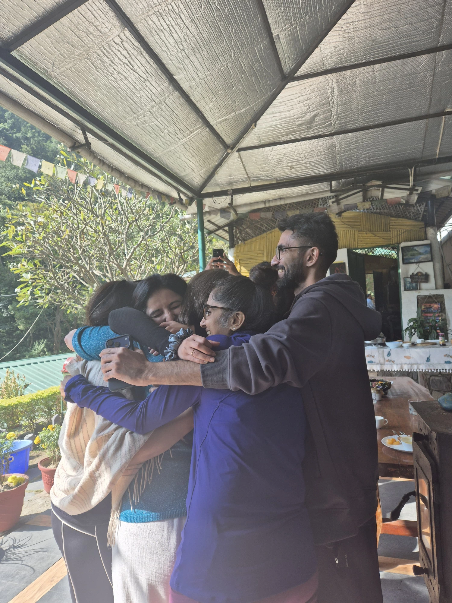 The group sharing a farewell hug on the last morning